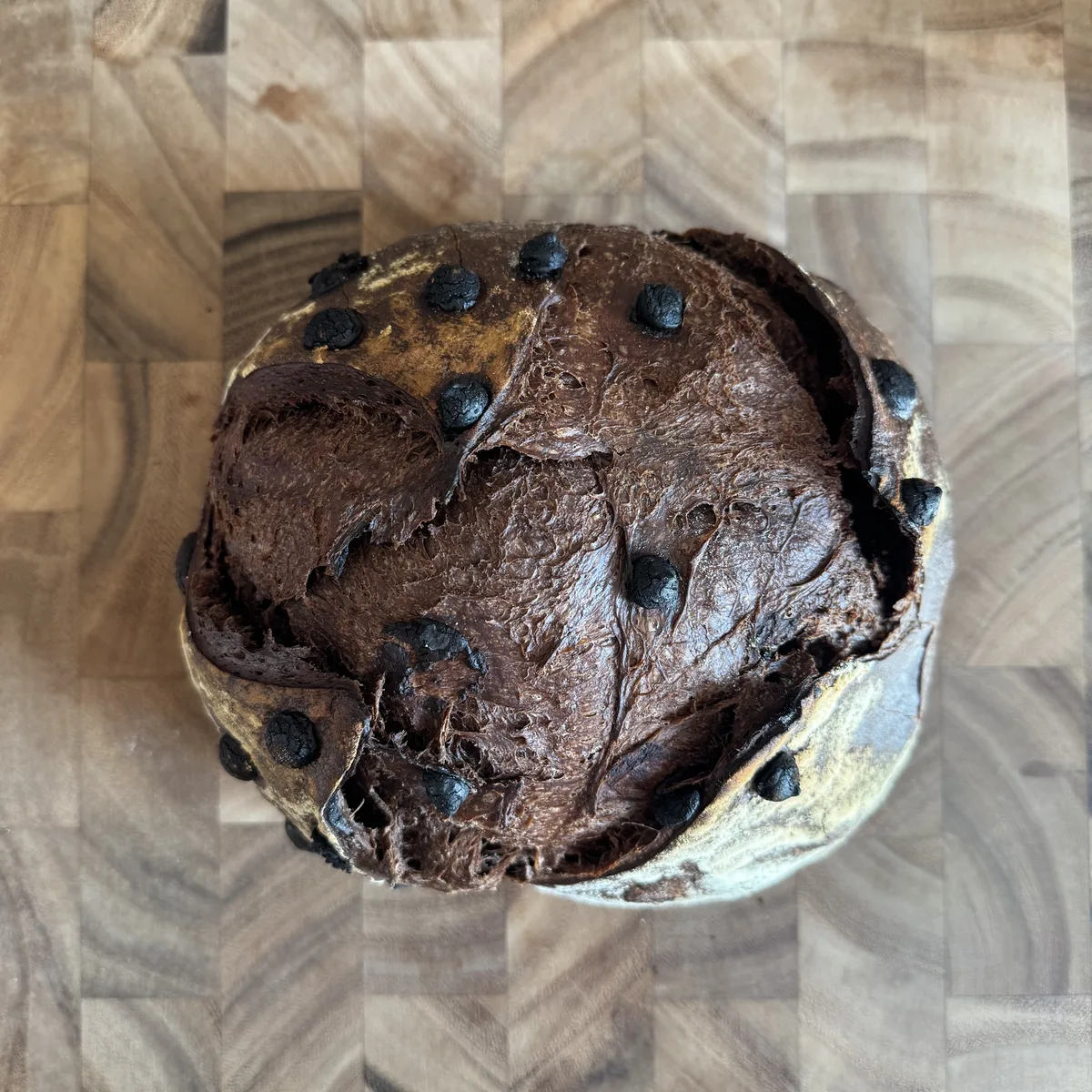 A Semisweet Chocolate loaf on a wooden end-grain board